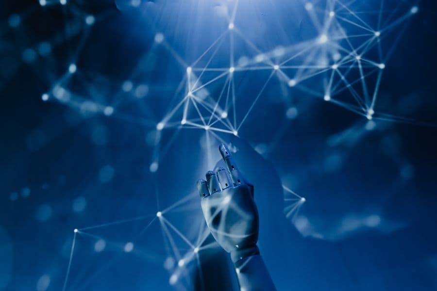 Robotic hand reaching into a digital network representing AI technology
