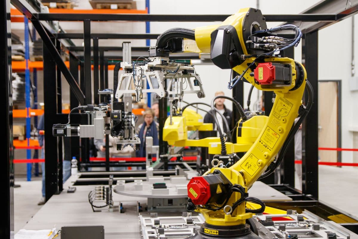 Industrial robotic arm in manufacturing facility representing robot training data collection for AI