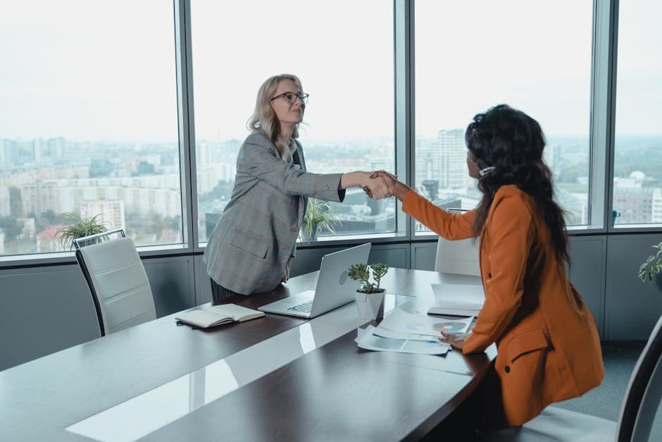 Two professionals shaking hands across a conference table – choosing the right data annotation partner is a strategic decision for AI teams